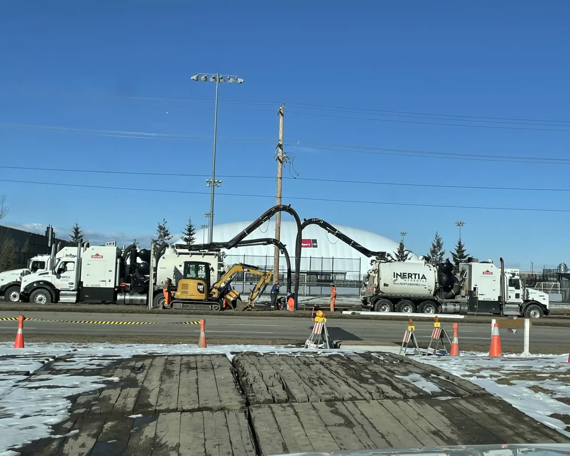 Hydrovac excavation and backfilling with stone slinger trucks